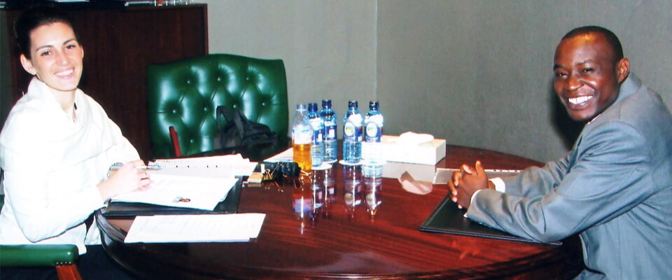 Two people seated across an office desk