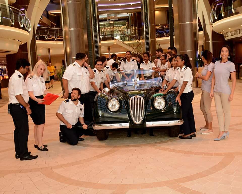 Staff gathered around a display in a hotel lobby