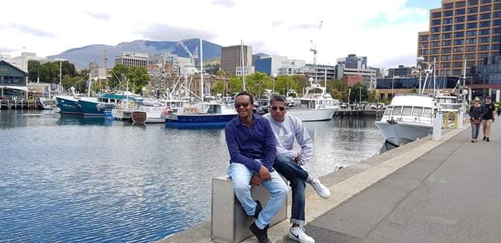 People posing beside the harbour