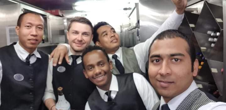 Hospitality staff taking a group photograph