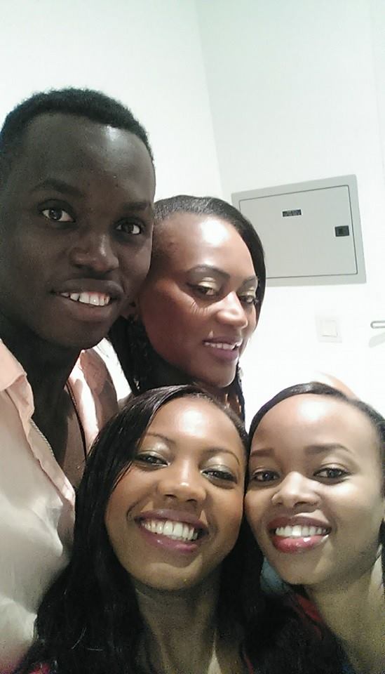 Four people posing together for a photograph
