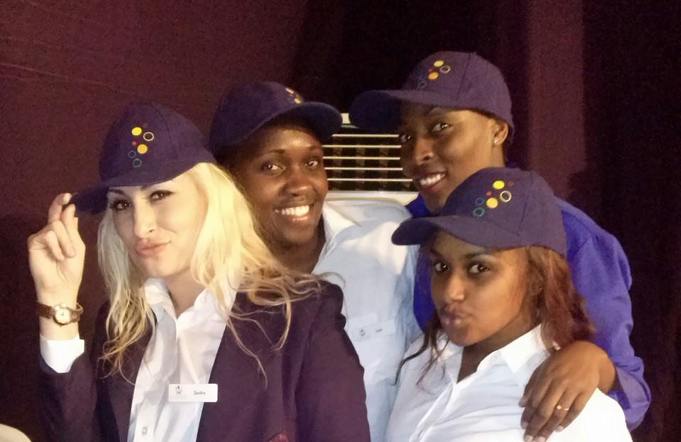 Airline crew members wearing purple hats