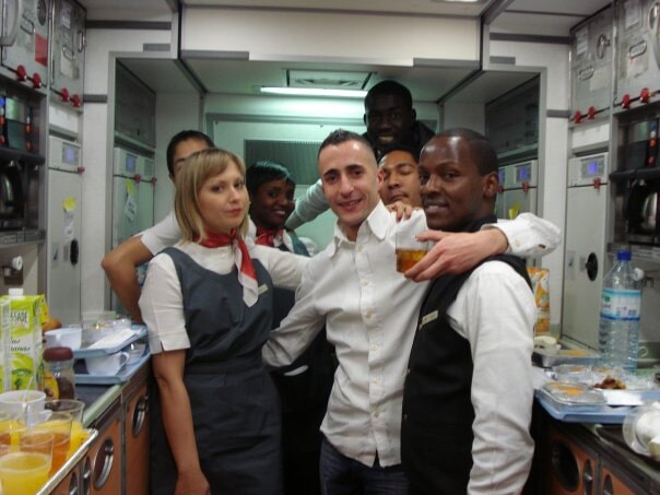 Hospitality staff posing together in a working kitchen